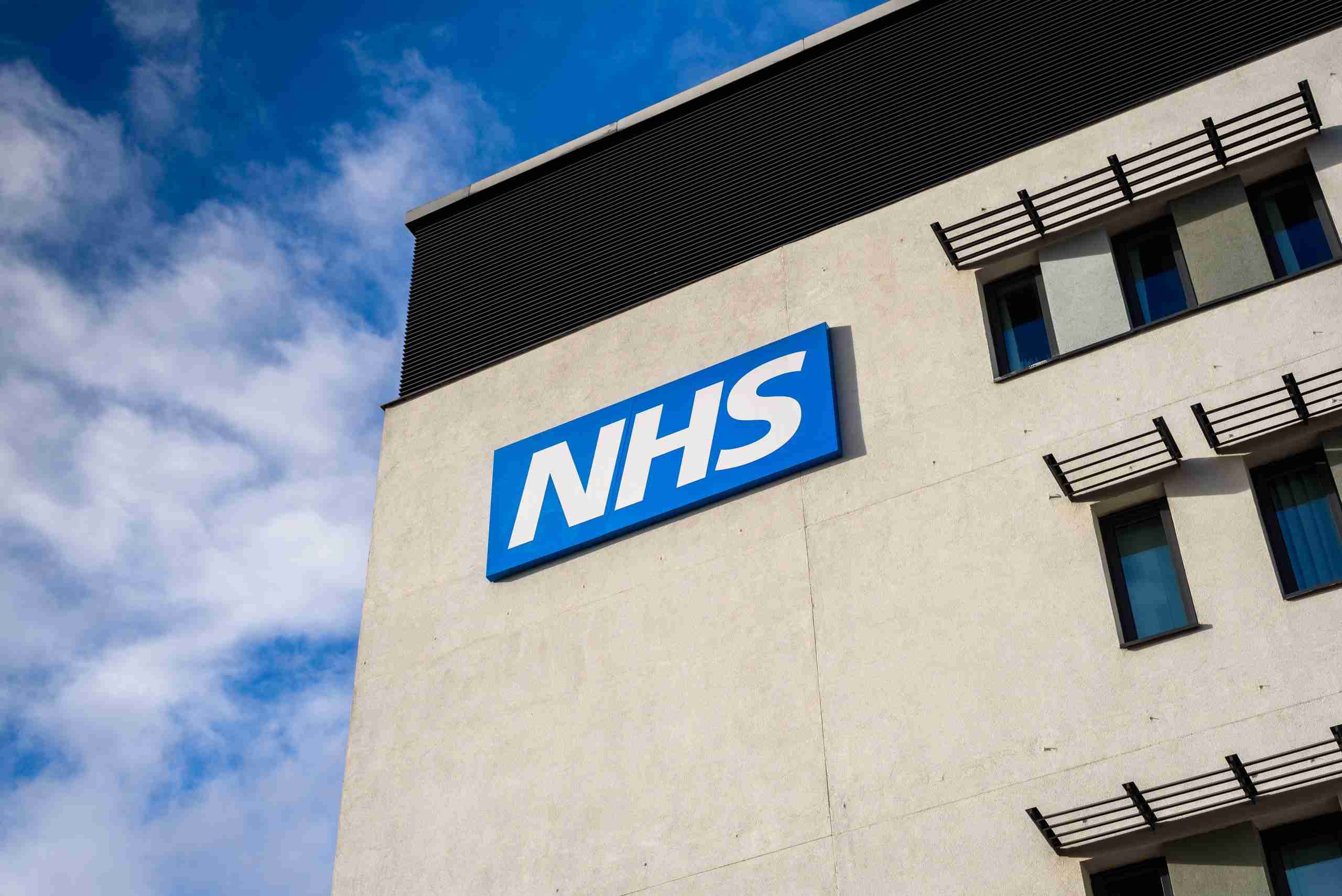 NHS sign on building in Warrington, England.