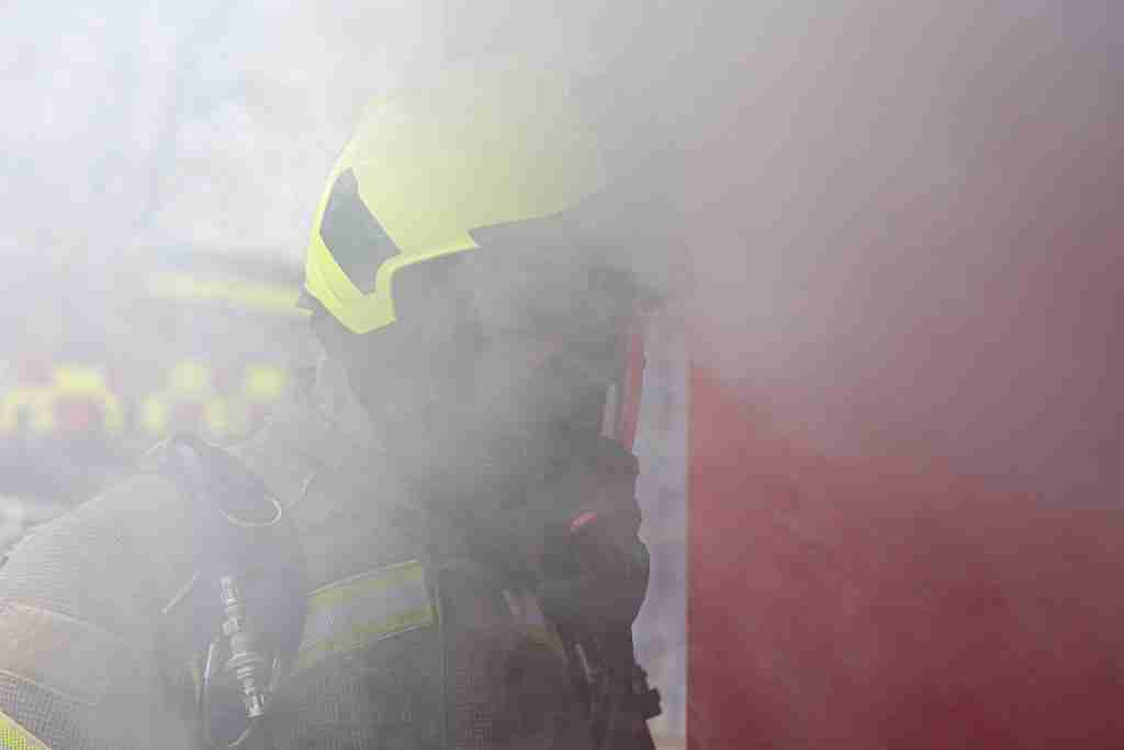 Firefighter obscured by smoke