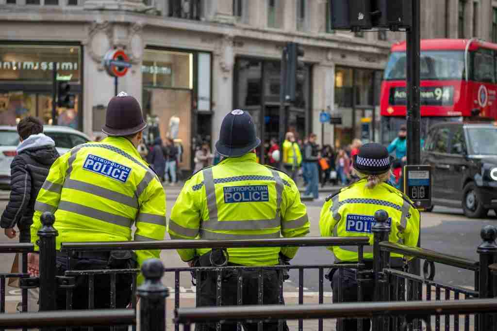 Three Met Police officers seen from behind in central London