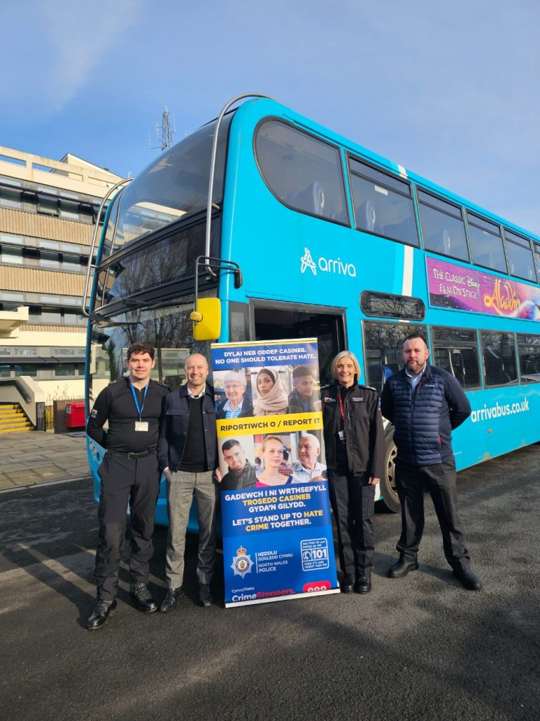 CC Amanda Blakeman with officers and Arriva staff in front of Arriva bus and poster
