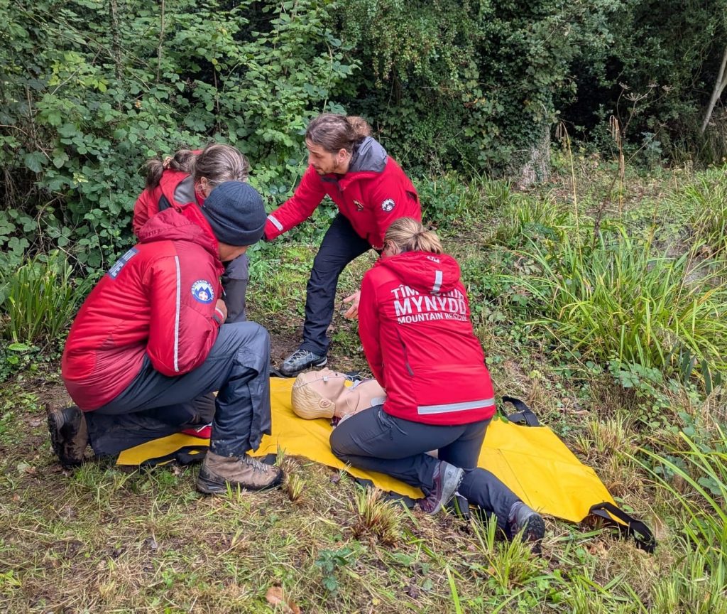 Mountain rescue volunteers training with patient.